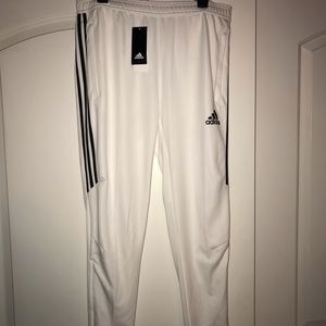 White with black strip adidas joggers.